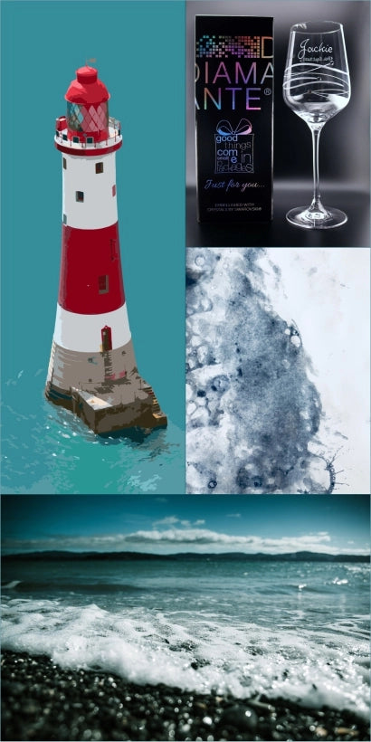 A composite image of Beachy Head Lighthouse, with its striking red and white stripes, stands on a rock islet amidst calm blue waters. Adjacent is a pebbled beach caressed by a foamy wave, under a clear sky with distant mountains. Artistic blue ink washes convey Eastbourne's seaside fluidity and dynamic nature. A wine glass bears the name 'Jackie,' elegantly engraved, paired with its DIAMANTE box, hinting at the luxury of Swarovski crystals.