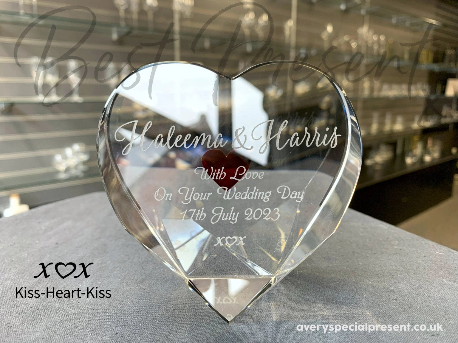 An optical Crystal Heart, Deeply Engraved Red Heart on the reverse, engraved names and message with a kiss-heart-kiss for a wedding - Front View. Different artwork showcasing kiss-heart-kiss.