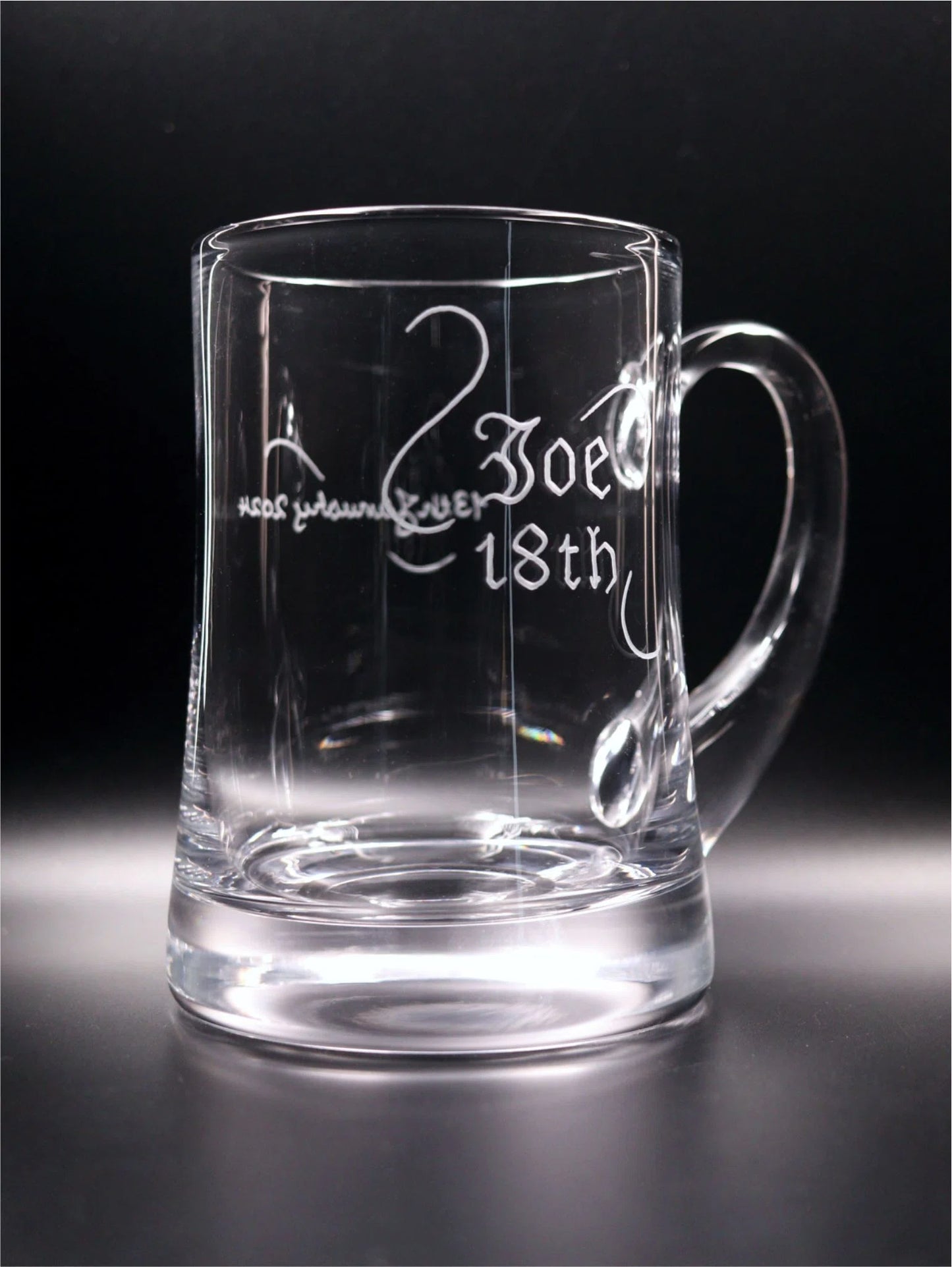 Handmade Aleman Tankard Hand Engraved with Joe, 18th in Old English and the date on the reverse side with a decorative scroll. Side View.