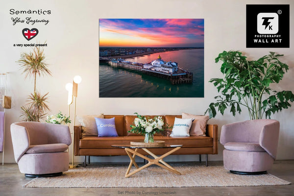 Living room with a large wall art print by TK Photography of a sunset over Eastbourne Pier, surrounded by furniture and decor.