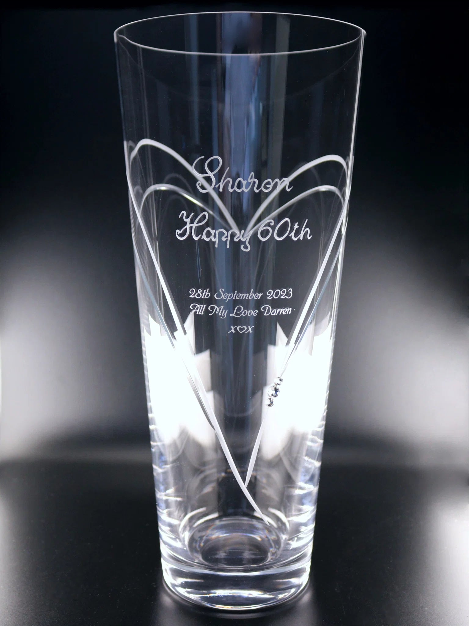 A sleek vase engraved with "Sharon Happy 60th 28th September 2023 All My Love Darren x ♡ x " alongside heart accents and sparkling crystals, commemorating a special 60th birthday with a personal touch.